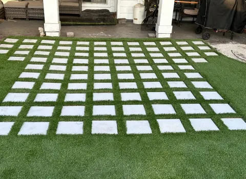 Artificial turf strips between concrete pavers