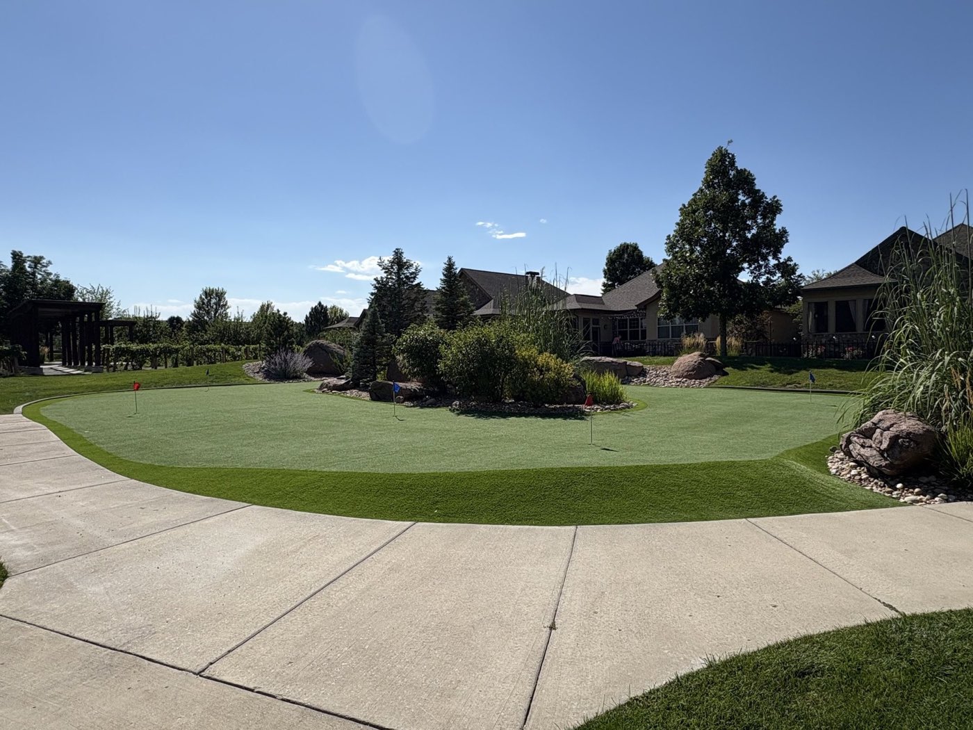 Backyard putting green seen from the driveway