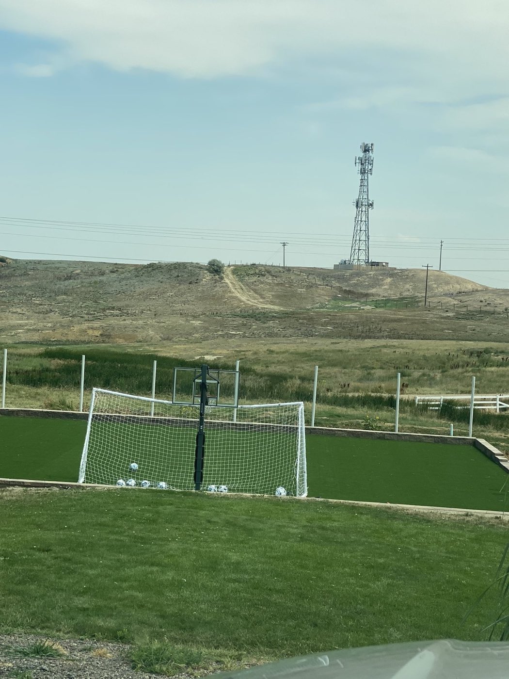 Artificial turf with practice nets and goals showing foot traffic