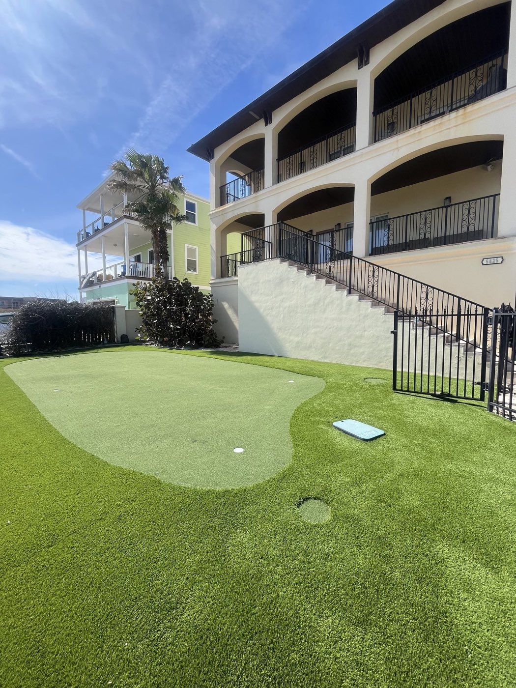 Shared amenity lawn beside a golf community putting green